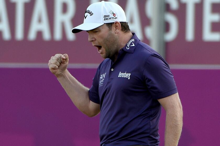 Branden Grace celebrates his birdie putt on the 18th green during his victory at the Qatar Masters on Saturday.