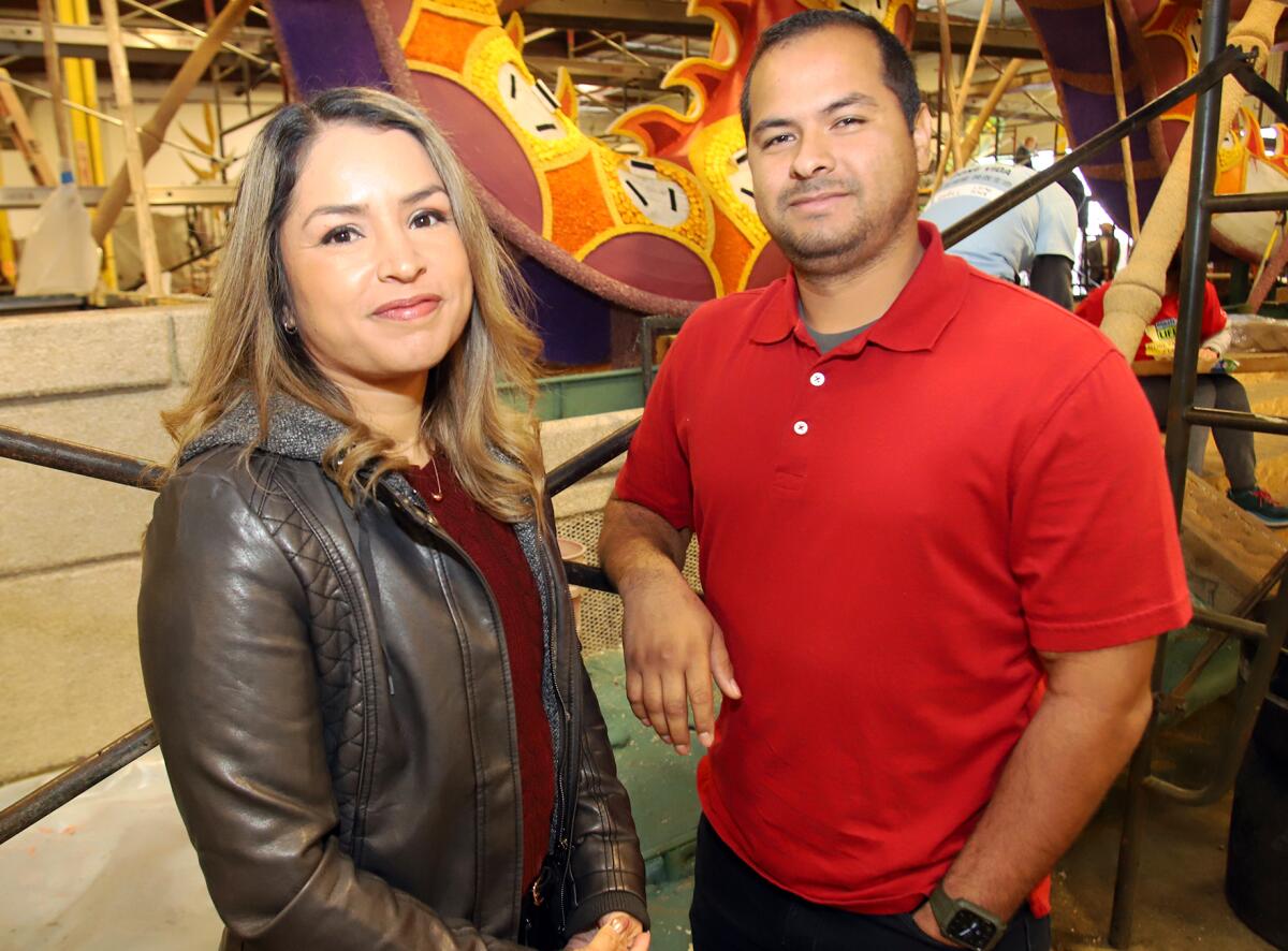 Yadira Ortega an her brother, Ricardo Ortega, stand in front of Donate Life's "Lifting Each Other Up" Rose Parade float.