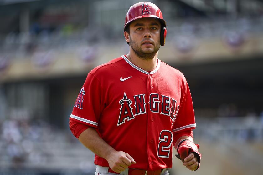 Los Angeles Angels' David Fletcher returns to the dugout after forced out at second base against the Minnesota Twins during the third inning of a baseball game Sunday, Sept. 24, 2023, in Minneapolis. The Twins won 9-3. (AP Photo/Craig Lassig)