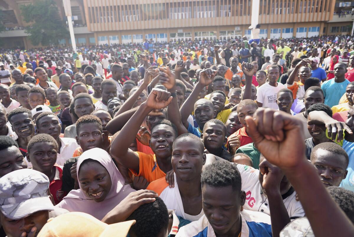 Angry young people gather Saturday in Niamey, Niger, to register to volunteer to fight for the junta.