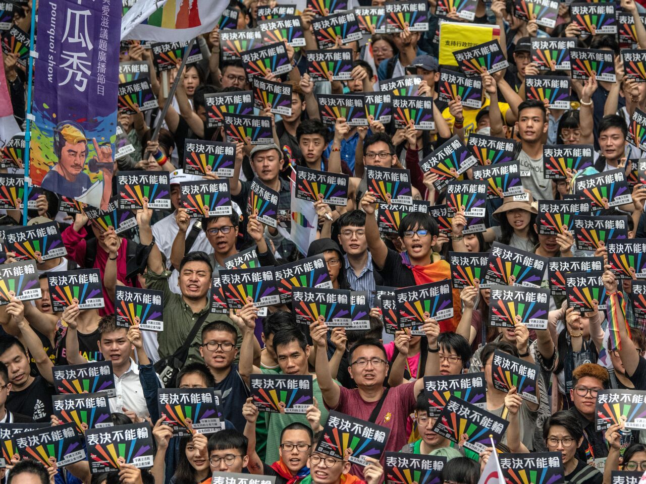 Taiwanese gather outside parliament in Taipei before Friday's vote legalizing same-sex marriage.