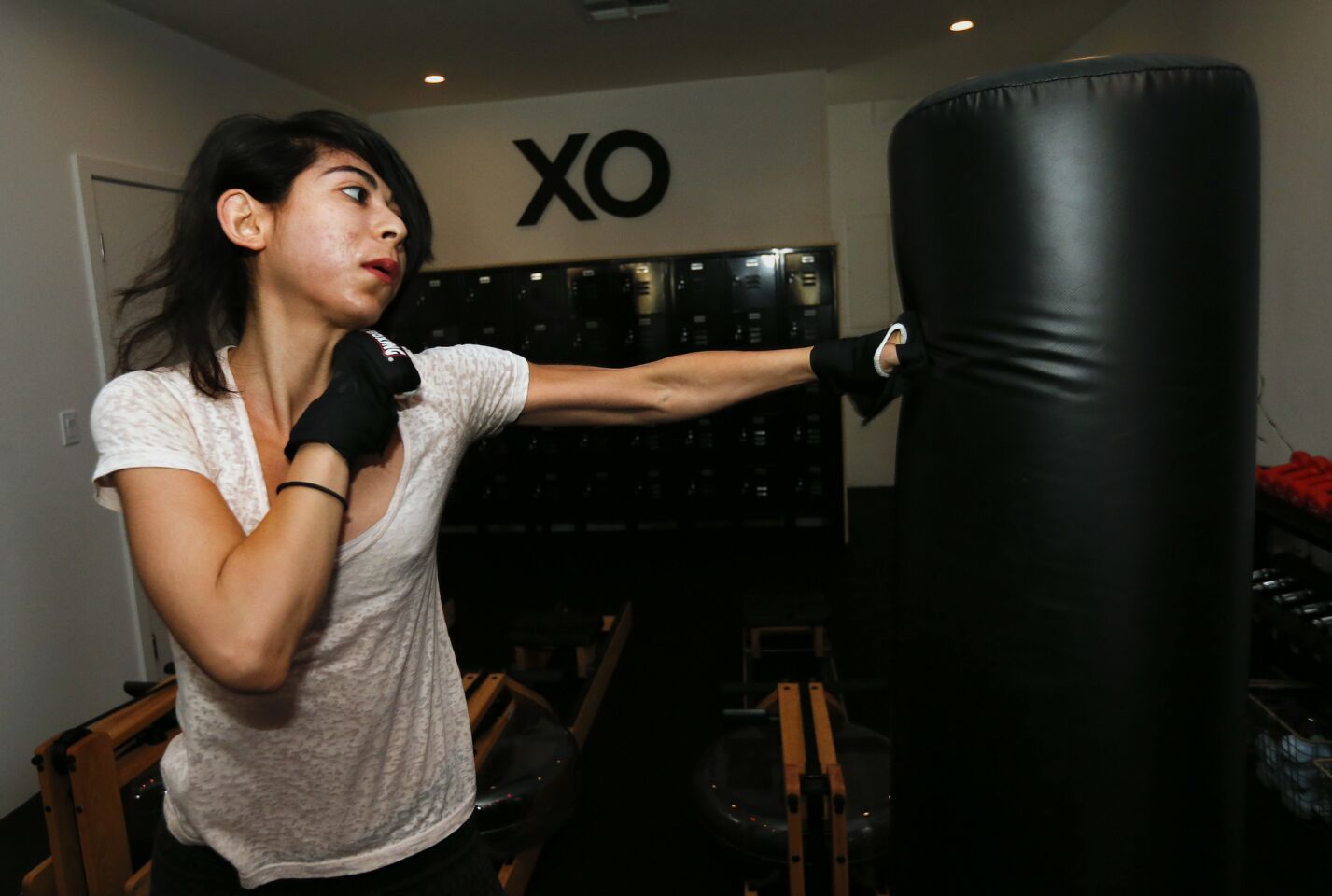 Jessica Rose Felix, 26, of Sherman Oaks works out on the heavy bag during a pilates+circuit+cardio workout at XO Cross Over Fitness.