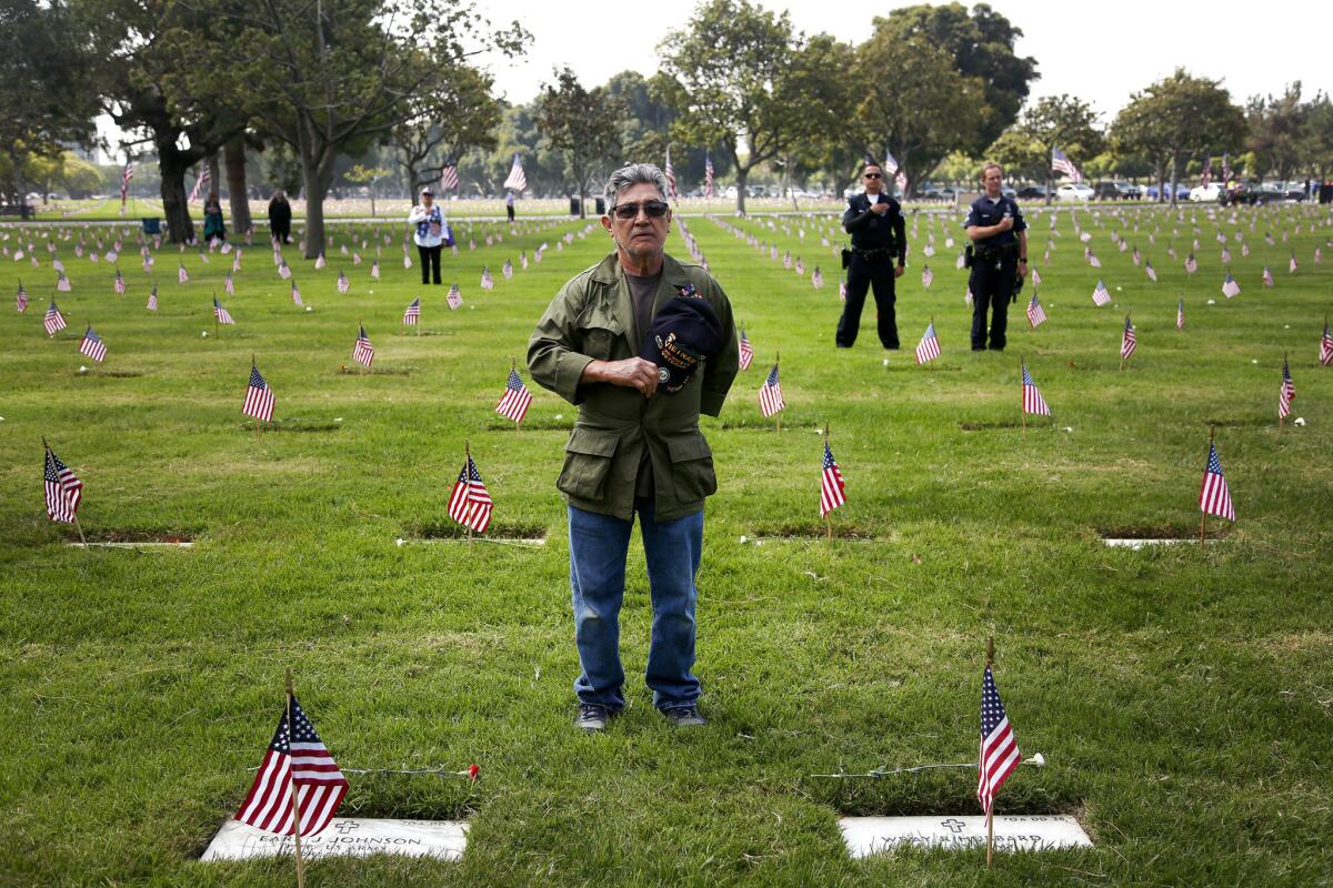 Alex Vigueras, a Vietnam veteran from Lawndale, says the Pledge of Allegiance during the Los Angeles National Cemetery's Memorial Day ceremony.