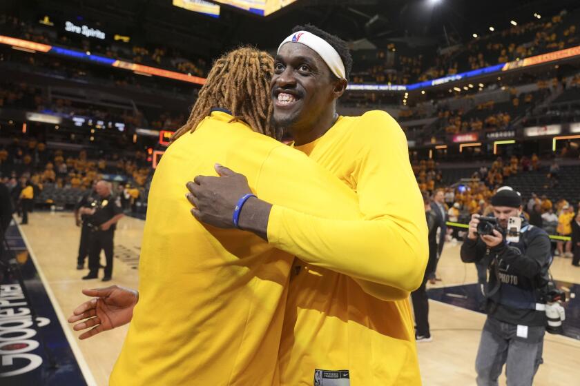 Indiana Pacers forward Pascal Siakam, right, gets a hug from teammate James Johnson after Game 6 against the Milwaukee Bucks in an NBA basketball first-round playoff series, Thursday, May 2, 2024, in Indianapolis. The Pacers won 120-98. (AP Photo/Michael Conroy)