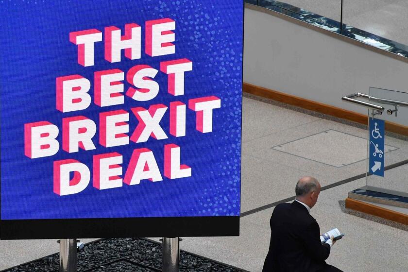 A delegate reads literature next to a sign that reads "The Best Brexit Deal" at the venue on the first day of the Conservative Party Conference 2018 at the International Convention Centre in Birmingham, on September 30, 2018. (Photo by Ben STANSALL / AFP)BEN STANSALL/AFP/Getty Images ** OUTS - ELSENT, FPG, CM - OUTS * NM, PH, VA if sourced by CT, LA or MoD **