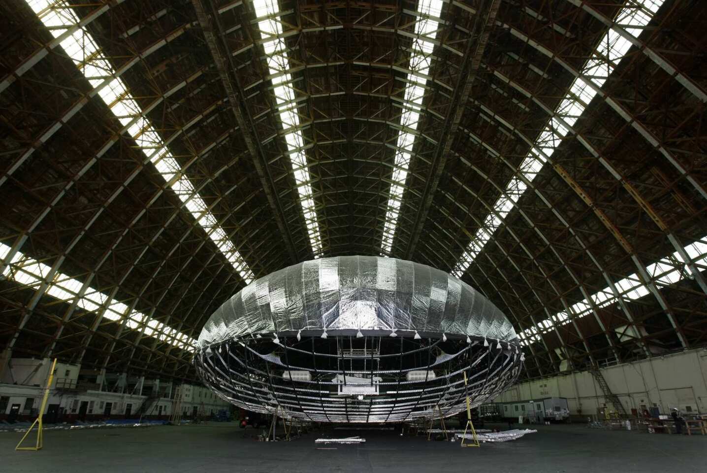 A new blimp-like airship is being constructed by Worldwide Aeros in a World War II-era blimp hanger at a former military base in Tustin. The airship will be used by the military to carry tons of cargo to remote areas around the world.