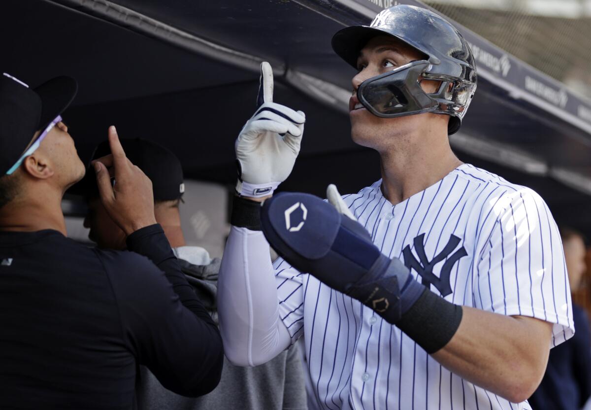 New York Yankees' Aaron Judge reacts in the dugout after scoring a run during the first inning of the team's baseball game against the Tampa Bay Rays on Saturday, Sept. 10, 2022, in New York. (AP Photo/Adam Hunger)