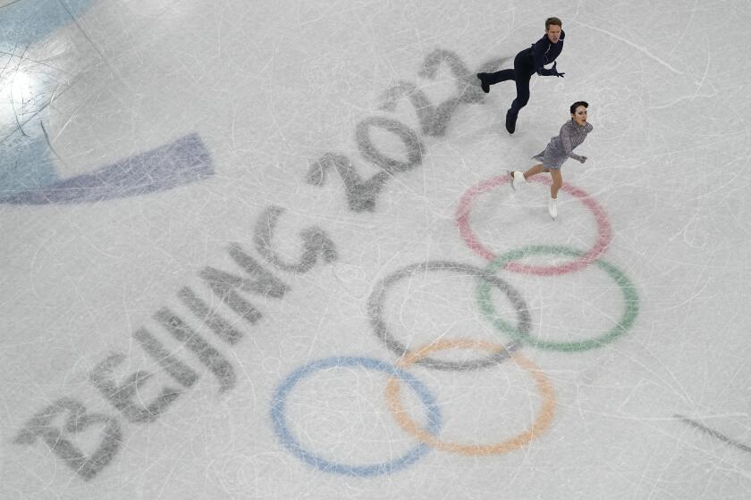 Madison Chock and Evan Bates, of the United States, compete in the team ice dance program during the figure skating competition at the 2022 Winter Olympics, Monday, Feb. 7, 2022, in Beijing. (AP Photo/Jeff Roberson)