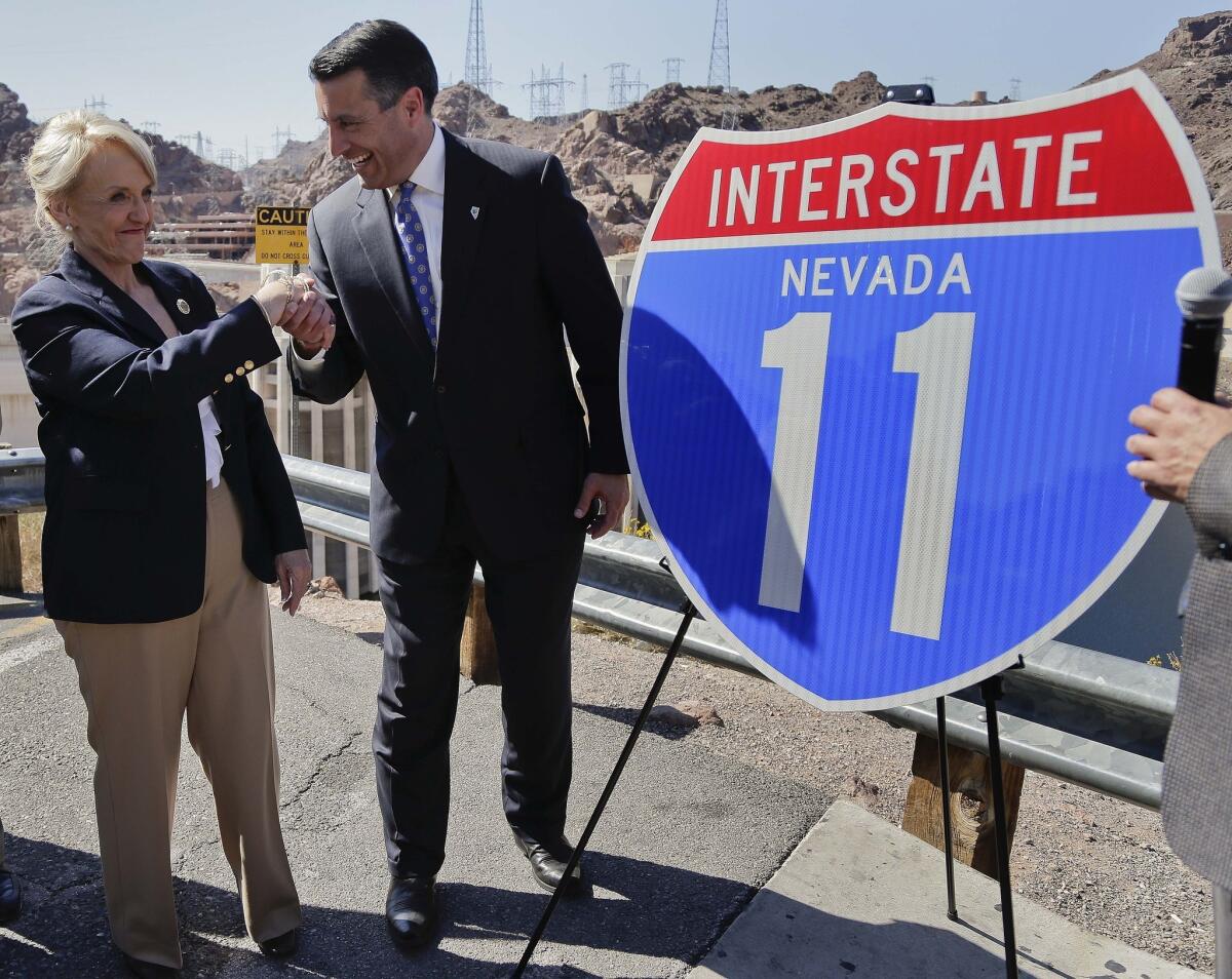 Republican Gov. Brian Sandoval of Nevada, pictured with Arizona Gov. Jan Brewer, has thrown cold water on the prospect of challenging Democratic Senate Majority Leader Harry Reid. But he won't rule it out entirely.