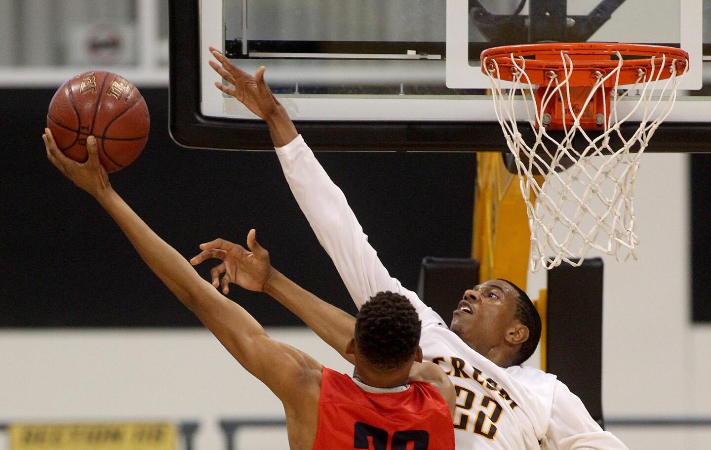 Crespi forward De'Anthony Melton challenges a shot by Redondo forward Wesley Gilbert in the first half.