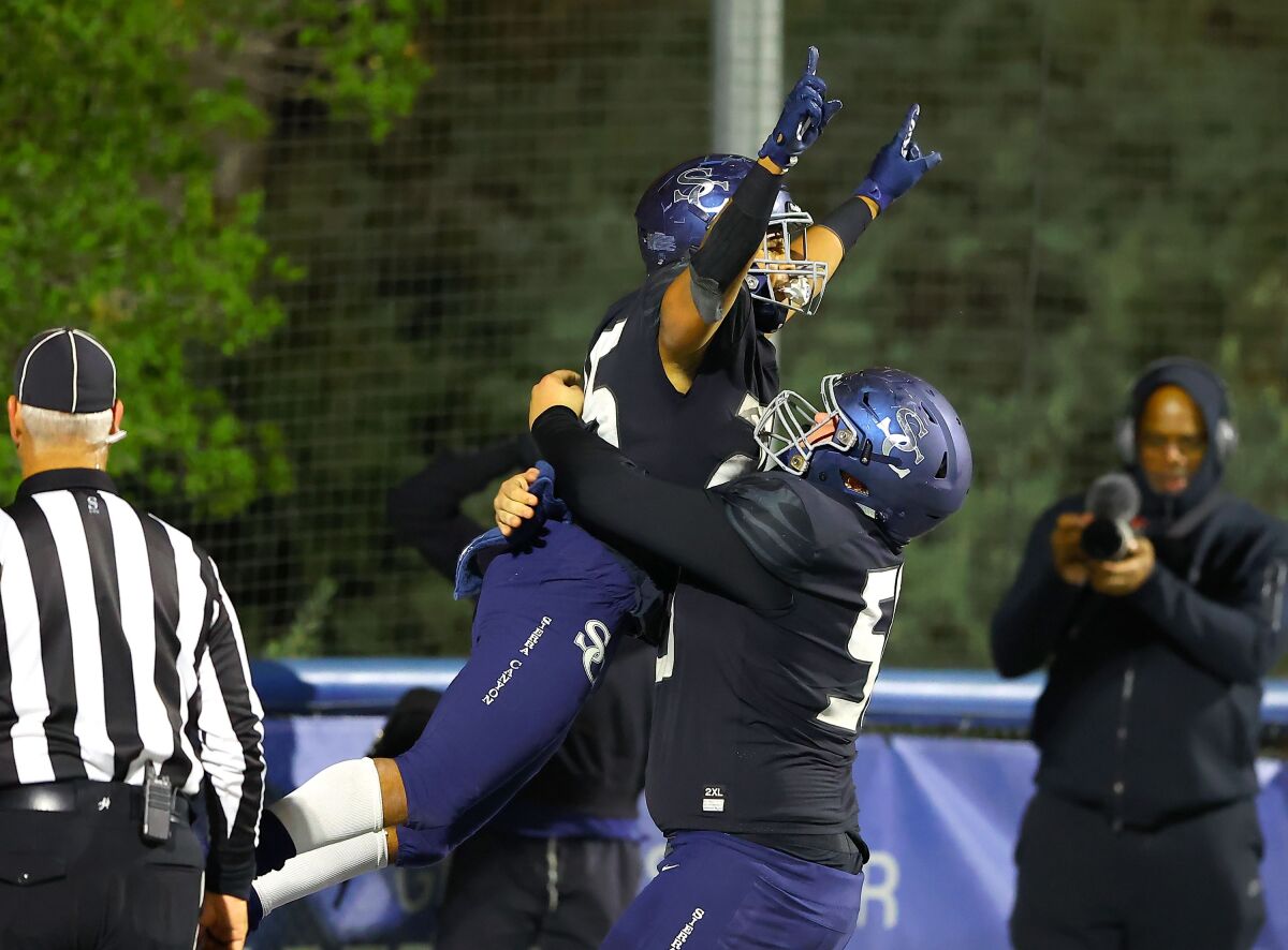 Sierra Canyon High running back Dane Dunn leaps into a teammates arms after scoring a touchdown.