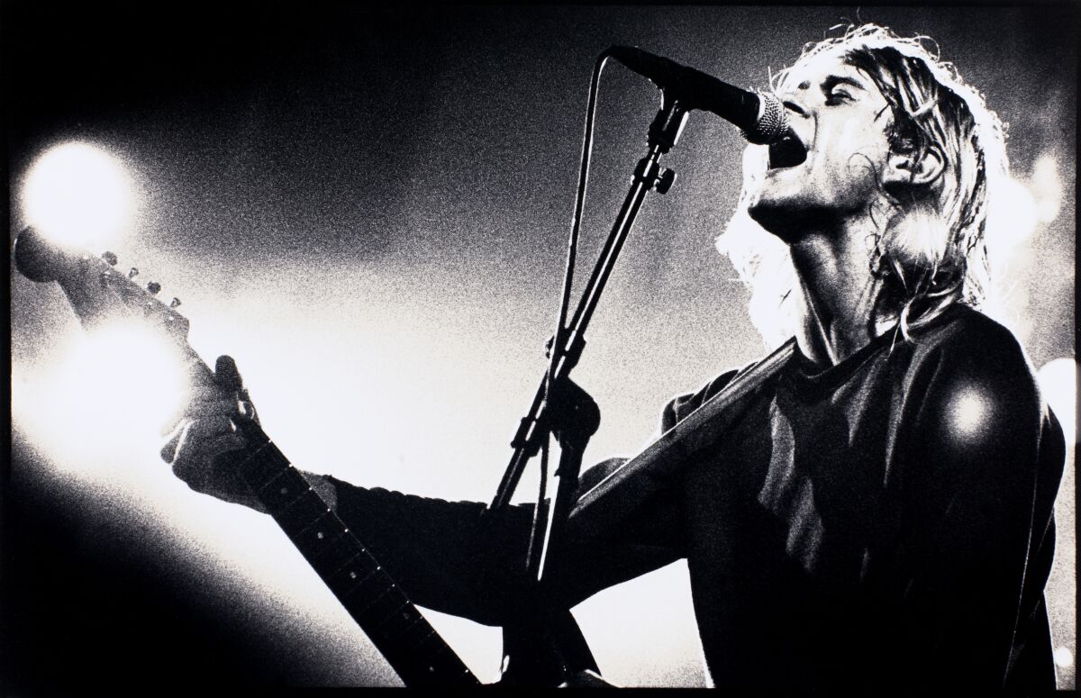 Kurt Cobain singing on stage.