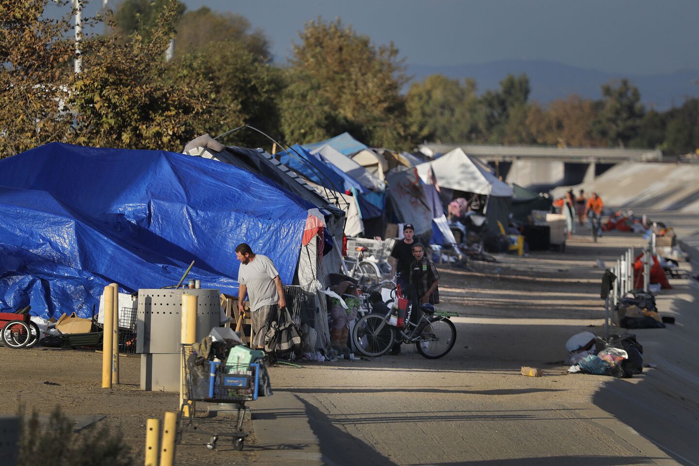 For hundreds of homeless who have created a makeshift community of tents and encampments along the Santa Ana River’s concrete edges between Fountain Valley and Anaheim, it’s time to either pack up or face arrest.