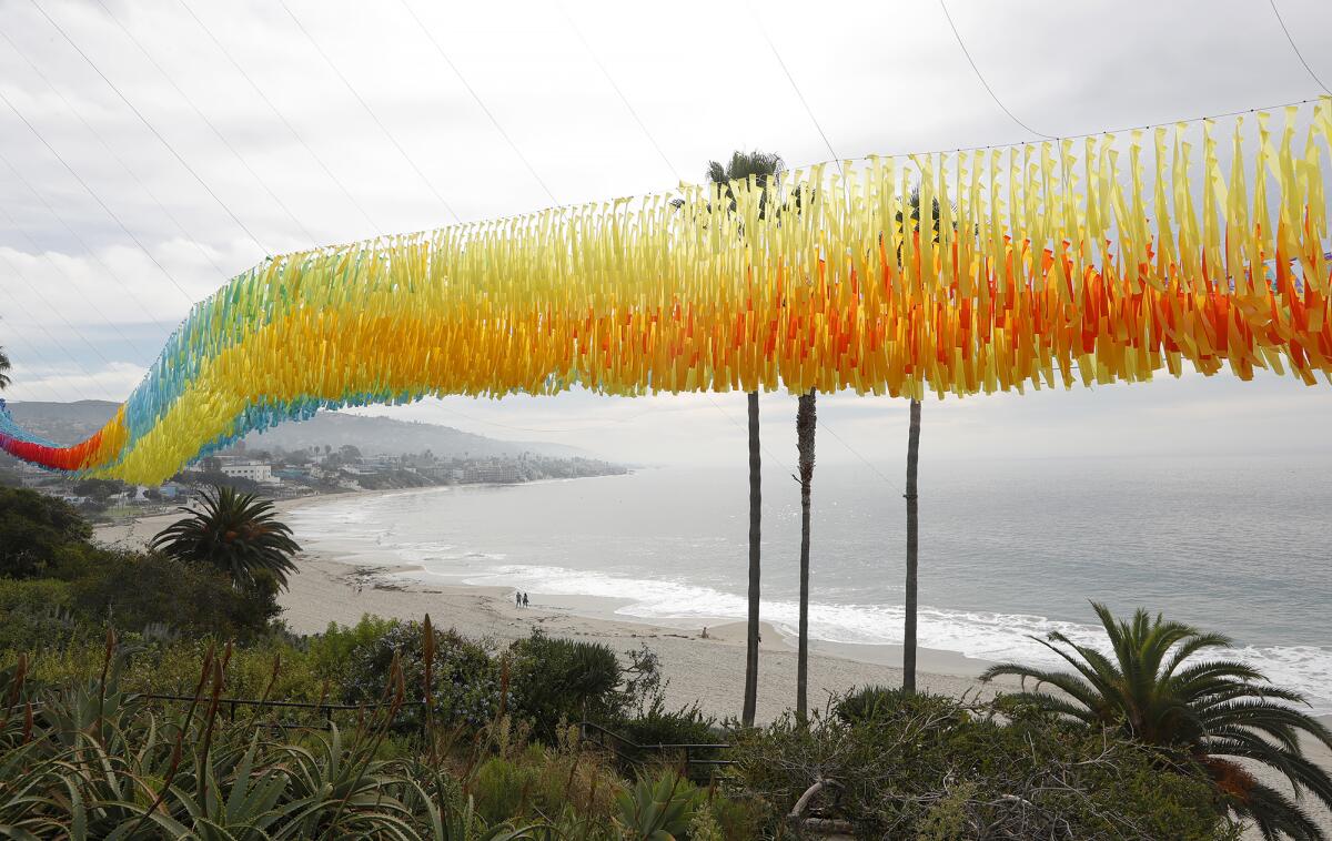 Laguna Beach Art Museum's Art and Nature exhibit, Patrick Shearn's "Sunset Trace" Skynet, suspended along the coastline.