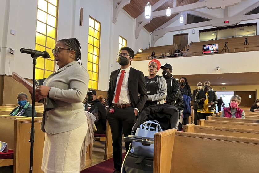 FILE - People line up to speak during a reparations task force meeting at Third Baptist Church in San Francisco on April 13, 2022. A report by California's first in the nation task force on reparations Wednesday, June 1 will document in detail the harms perpetuated by the state against Black people and recommend ways to address those wrongs. (AP Photo/Janie Har, File)