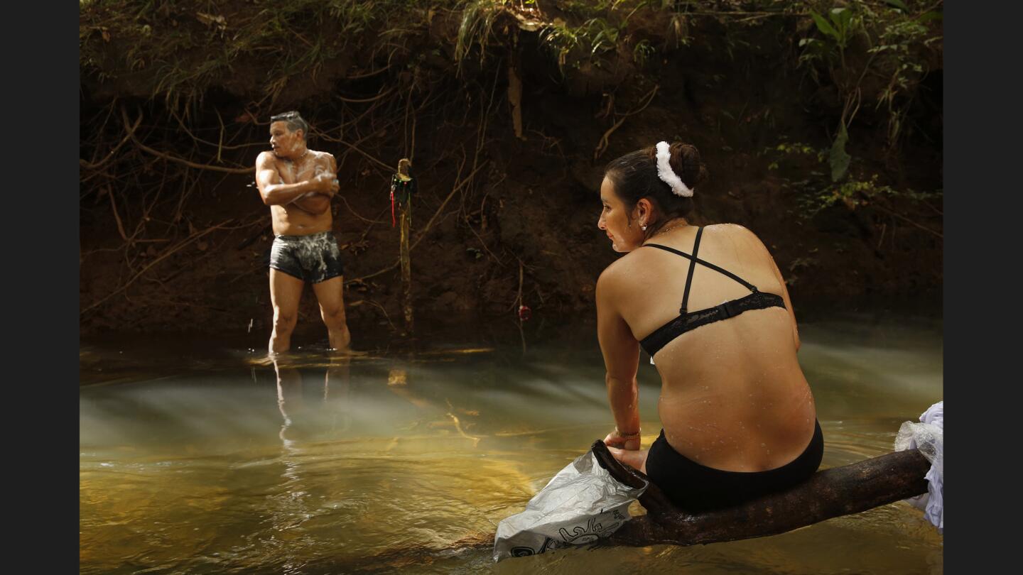 Revolutionary Armed Forces of Colombia member Viviana, 28, and her comrade Jon, 34, bathe in spring waters by their camp. "We're all kids of the same town and we've been killing each other," Viviana says regarding the long war in the region between the FARC and paramilitary forces.