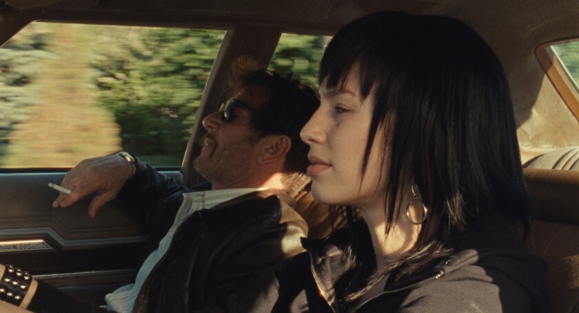A man and a woman in a car in the movie "Flag Day."