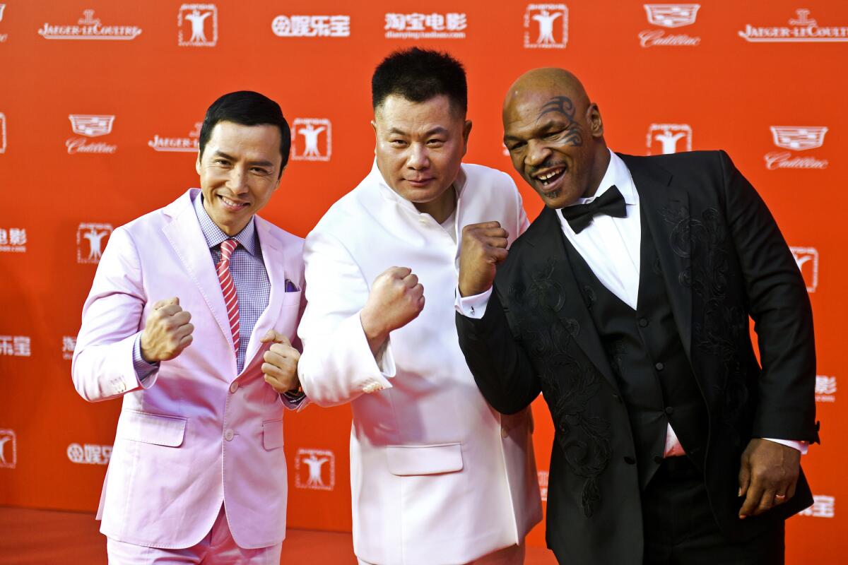 Actor Donnie Yen, left, producer Shi Jianxiang and Mike Tyson pose on the red carpet during the opening ceremony of the 18th Shanghai International Film Festival on June 13, 2015.
