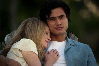 Julianne Moore as Gracie Atherton-Yoo snuggles on the shoulder and chest of Charles Melton as Joe in the film 'May December'