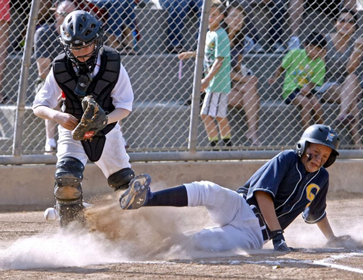 Crescenta Valley's Braenden Bentzen, right, slides in safe as Foothill's catcher Andy Hovland goes for the ball.