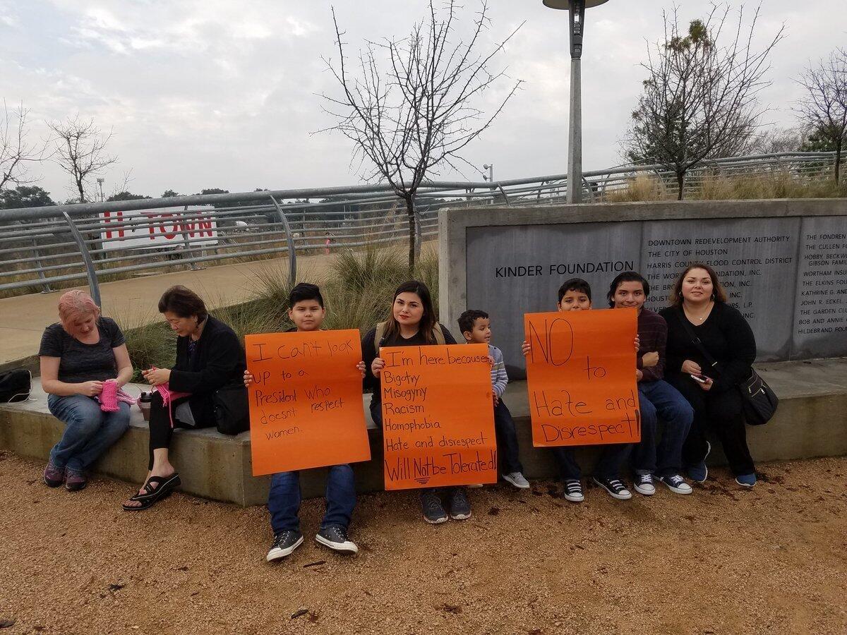 Elizabeth Arreola, center, brought her son and nephews to the march in Houston.