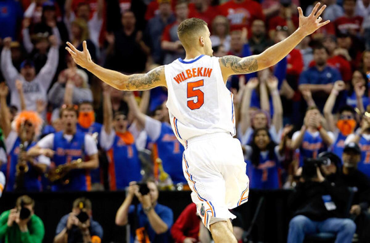 Florida guard Scottie Wilbekin celebrates after hitting a three-pointer to end the first half against Dayton in the South Regional final on Saturday evening in Memphis, Tenn.
