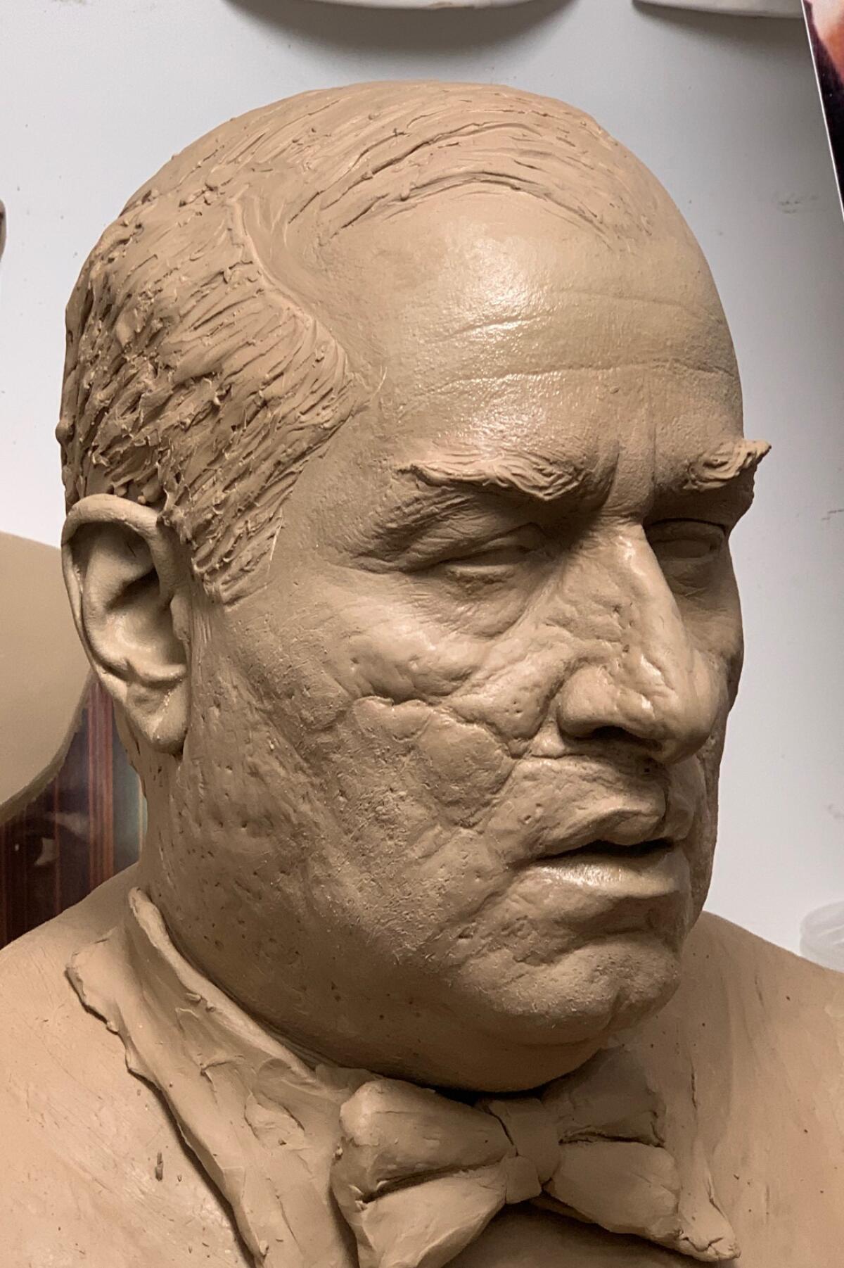 A bust depicts a balding man's scarred face in the negative for a prosthetic sculpture.
