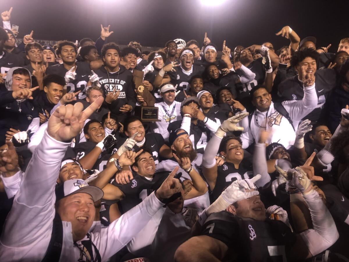 St. John Bosco players and coaches celebrate bowl victory in 2019.