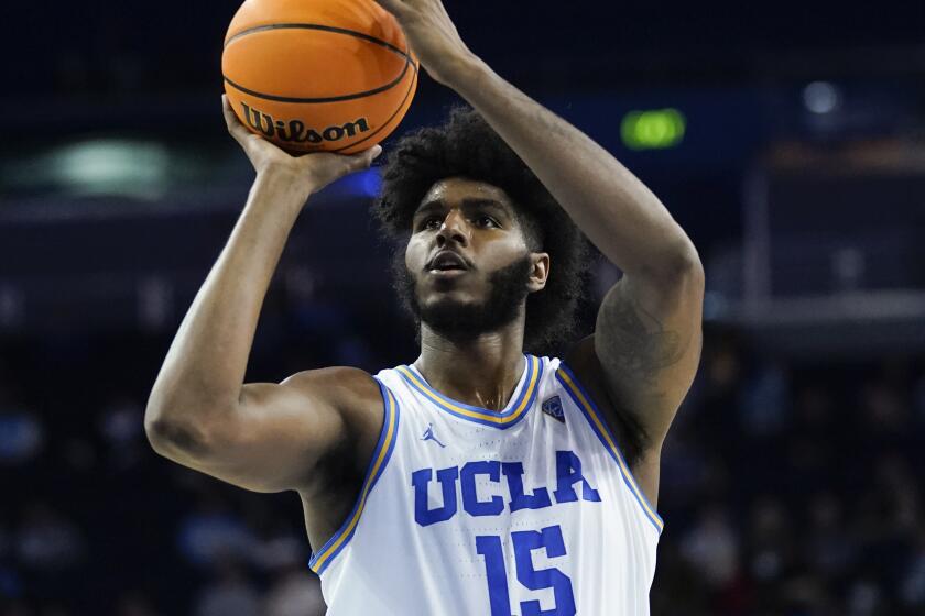 UCLA center Myles Johnson (15) shoots during an NCAA college basketball game against Colorado in Los Angeles, Wednesday, Dec. 1, 2021. (AP Photo/Ashley Landis)