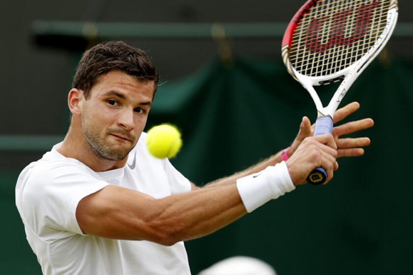 Grigor Dimitrov gets set to hit a backhand against Grega Zemlja during their second-round match at Wimbledon on Friday. Zemlja's 3-6, 7-6, 3-6, 6-4, 11-9 victory ended only the 12th five-set match in the first two men's singles rounds, the fewest at Wimbledon in the Open era.