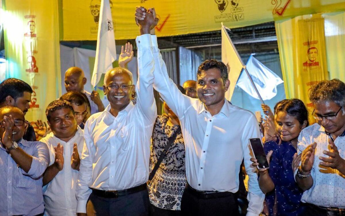 Maldives' opposition presidential candidate Ibrahim Mohamed Solih, left, and his running mate Faisal Naseem celebrate their victory in the presidential election in Male, Maldives on Sept. 24.