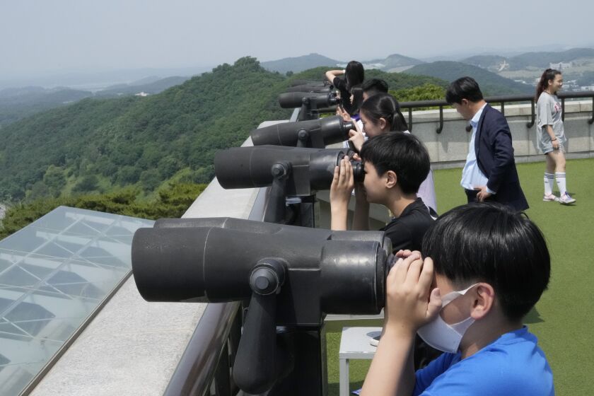 Elementary school students watch the North Korea side from the Unification Observation Post in Paju, South Korea, near the border with North Korea, Wednesday, May 31, 2023. North Korea's attempt to put the country's first spy satellite into space failed Wednesday in a setback to leader Kim Jong Un's push to boost his military capabilities as tensions with the United States and South Korea rise. (AP Photo/Ahn Young-joon)