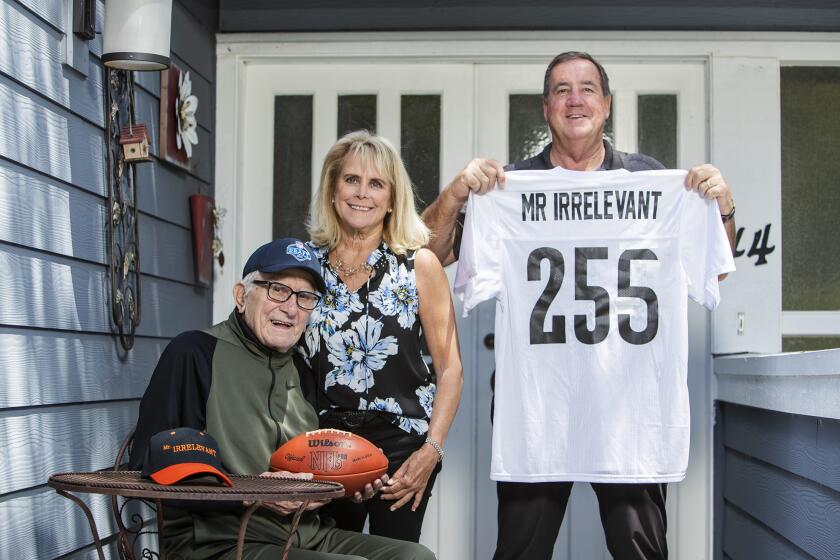 Paul Salata, left, with Melanie and Ed Fitch prepare for the NFL draft and Mr. Irrelevant.