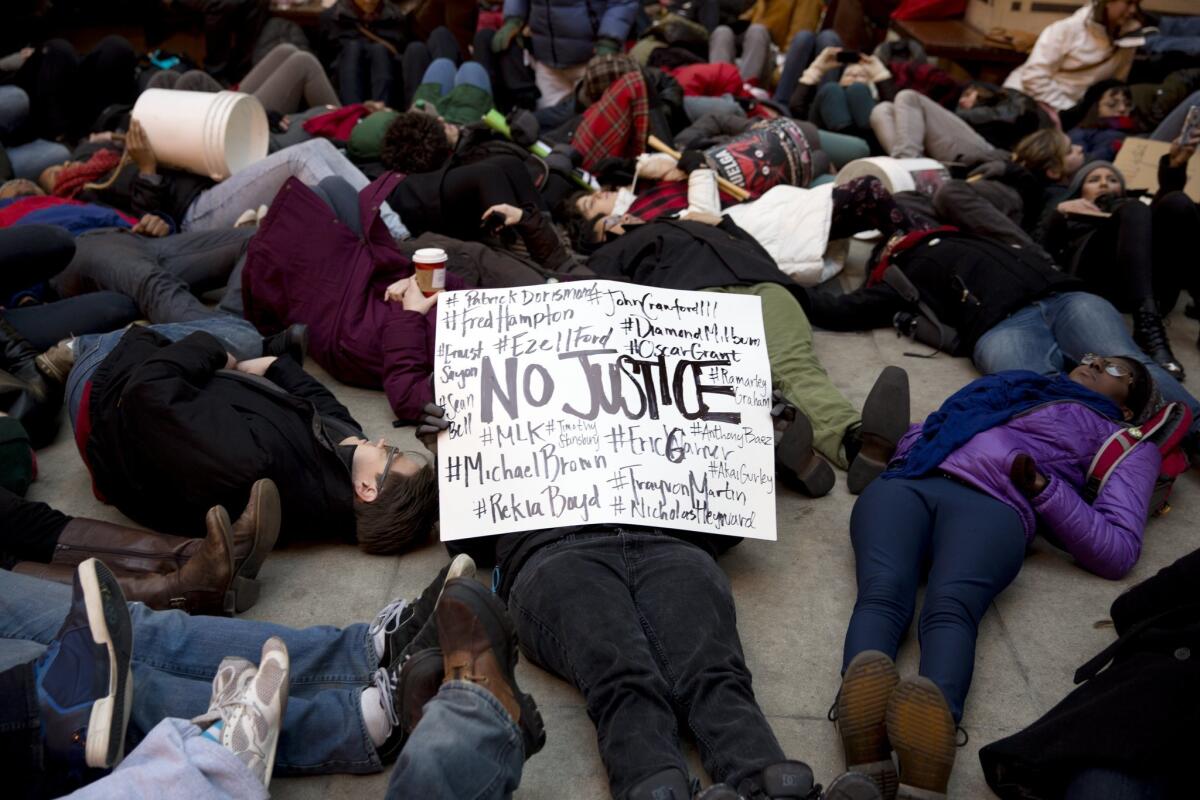 Demonstrators in Chicago protest the grand jury decisions not to indict the police officers responsible for the deaths of Michael Brown in Ferguson, Mo., and Eric Garner in New York.