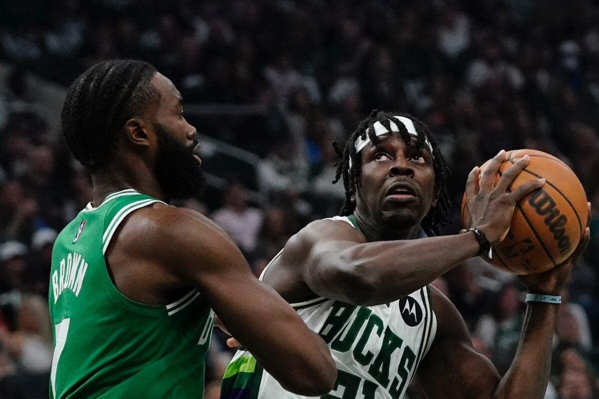 The Bucks' Jrue Holiday looks to shoot against the Celtics' Jaylen Brown during Game 3 on May 7, 2022.