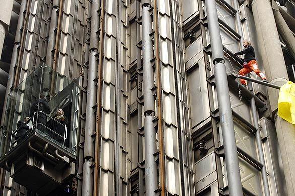 French extreme climber Alain Robert, in orange pants, climbs the Lloyd's building in the City of London on Thursday to unfurl a banner drawing attention to global climate change. World leaders are meeting in London during a G-20 summit to develop a cohesive economic strategy. • Photos: Obama in Europe • Photos: NATO protests • Complete coverage: Obama at the G20 and NATO Summits