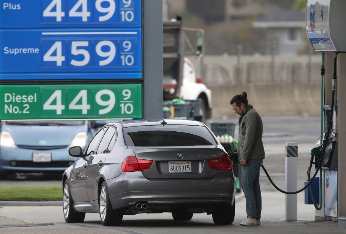 A driver is seen on July 3 pumping gas in Mill Valley, Calif., where prices are well above $4 per gallon.