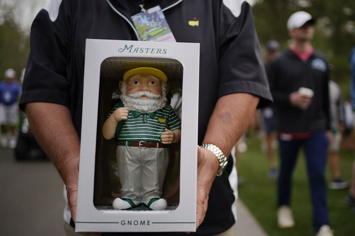 Dan Szatkowski, North Augusta, S.C, poses with his newly purchased garden gnome during a practice round for the Masters golf tournament on Tuesday, April 5, 2022, in Augusta, Ga. (AP Photo/Robert F. Bukaty)
