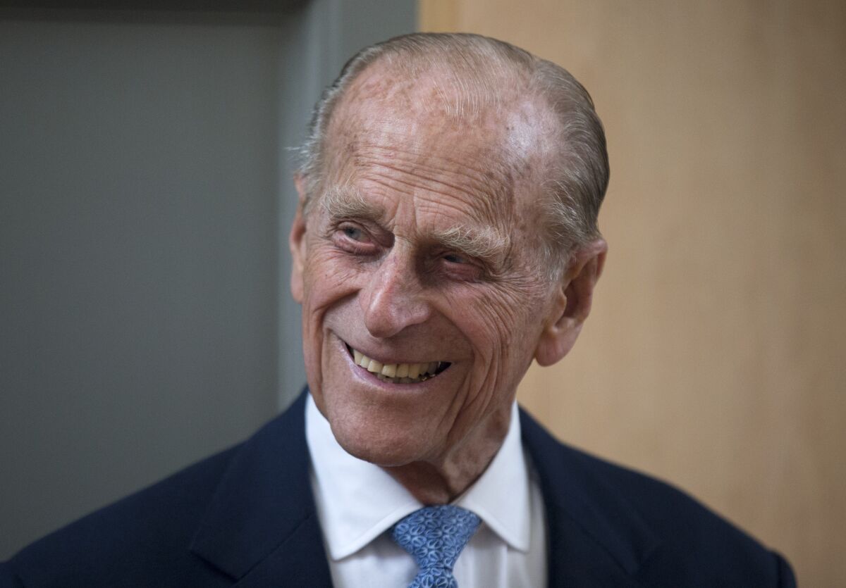 FILE - In this June 8, 2015 file photo, Britain's Prince Philip, the husband of Queen Elizabeth II, smiles after unveiling a plaque at the end of his visit to Richmond Adult Community College in Richmond, south west London. A judge ruled Thursday Sept. 16, 2021, that the will of the late Prince Philip should remain secret to protect the “dignity” of his widow Queen Elizabeth II, who is Britain’s head of state. (AP Photo/Matt Dunham, File)