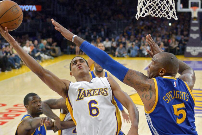 Lakers guard Jordan Clarkson, left, puts up over Golden State Warriors forward Marreese Speights in the Lakers' 136-115 loss at Staples Center on Nov. 16.