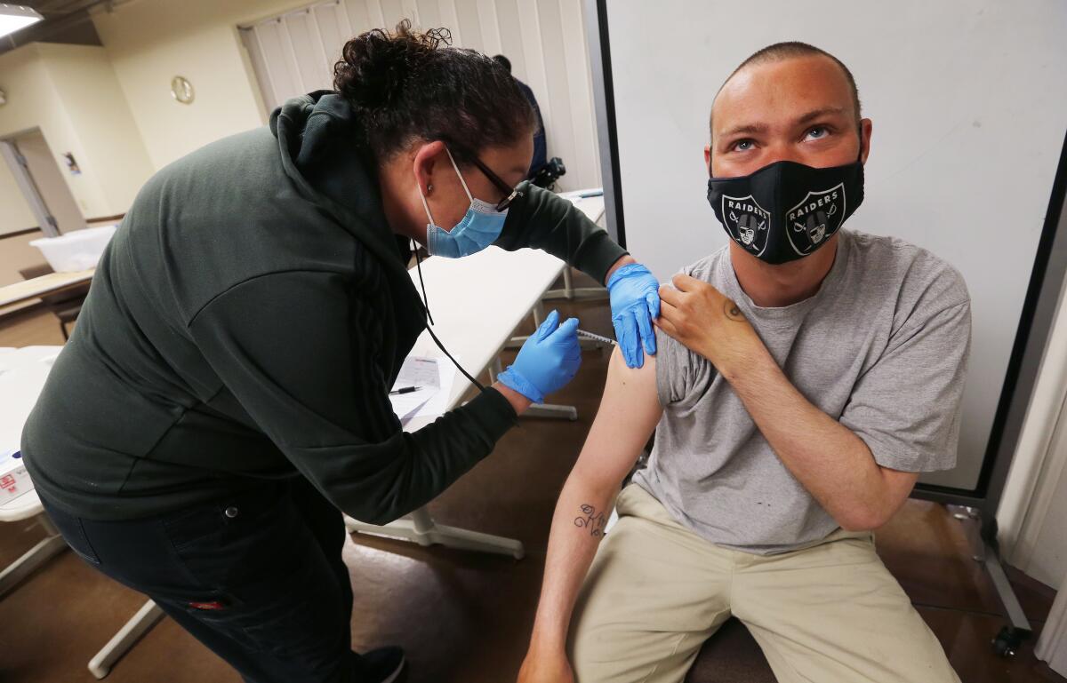 A woman administers a vaccine.