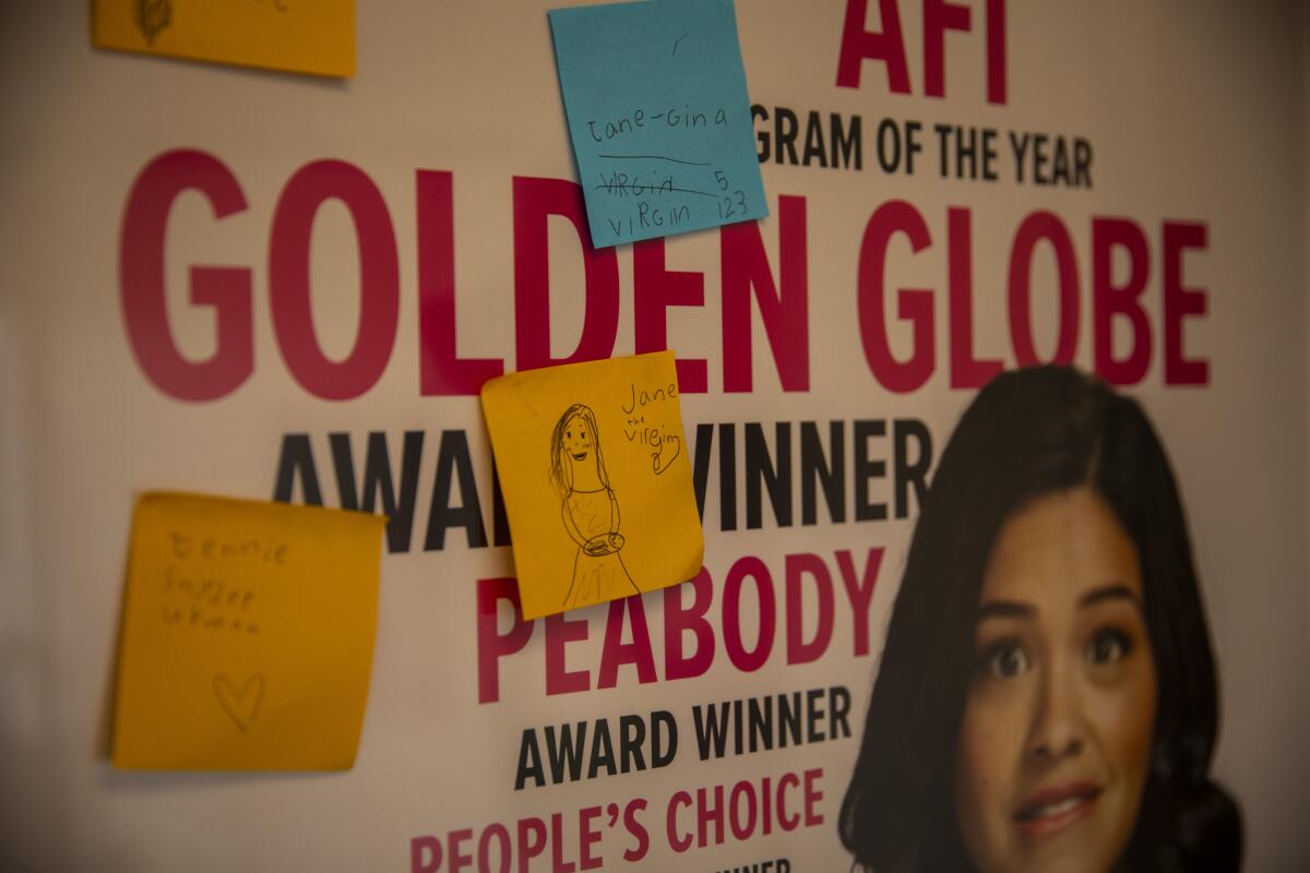 A "Jane the Virgin" poster with Gina Rodriguez's face and sticky notes on it.