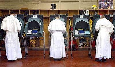 Frater Brendan Hankins, Frater Simon Guerena and Father Norbert Wood from the Saint Michael's Prepatory High School of the Nornertine Fathers cast their votes at the Orange County Fire Authority Station 18 in Trabuco Canyon Tuesday afternoon.