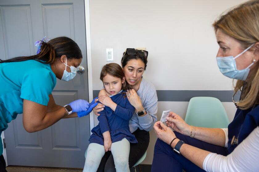 Los Angeles, CA - March 25: Dr. Neville Anderson, right, tries to cheer up and distract Perry Roj, 4, while nurse Breanna Kirby, left, gives her DTap Polio vaccination while her mom, Devin Homsey holds her at Larchmont Pediatrics in Los Angeles Tuesday, March 25, 2025. At the popular Larchmont Pediatrics, Dr. Neville Anderson requires all infants to begin their routine vaccinations by the three month visit. Parents who refuse receive a letter in the mail stating that they have 30 days to find a new doctor. "If a parent is truly anti-vax and does not want to vaccinate their child, our values and our goals and our beliefs are so antithetical to each other that we're not a good team," said Anderson. "I'm not the right doctor for them, and they're not the right patient for me." Larchmont only dismisses 1-4 patients each year, she said, since most anti-vaccine families know their reputation and tend to go elsewhere. For some patients, the dismissal policy is a real draw. As yet another measles outbreak continues to spread in Texas and New Mexico, with the first two measles deaths in the U.S. in a decade, physicians are again facing a moral quandary: Should they refuse to see families who don't want to vaccinate their children, or keep them in their practices in the hopes of changing their minds? (Allen J. Schaben / Los Angeles Times) 3pm Dr. Anderson sees a 4 year old patient who is getting vaccines 4:15pm A baby is getting a vaccine, but Dr. Anderson will not be there. The parent said it's fine to shoot her face and get artful phots of the vaccination, baby -- but she doesn't want her baby's face photographed. 8:52 4:30pm Dr. Anderson will be seeing another 4 year old patient who is getting vaccines