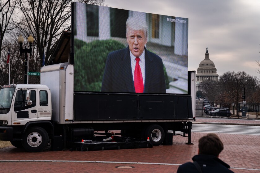 President Trump on a screen mounted to a truck.