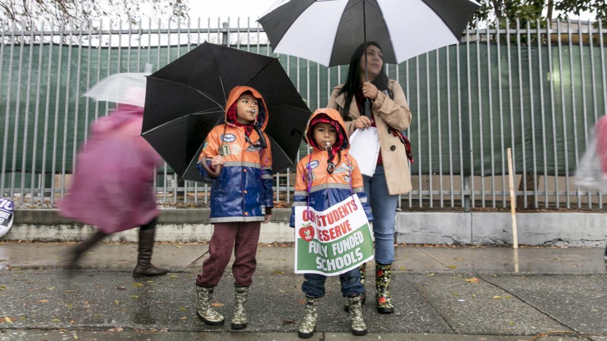 Veronica Metz, 41, a fourth-grade teacher at the 99th Street Elementary School, and her two sons, Daniel, 5, center, and Jeremy, 7, join members of United Teachers Los Angeles in support of the strike.