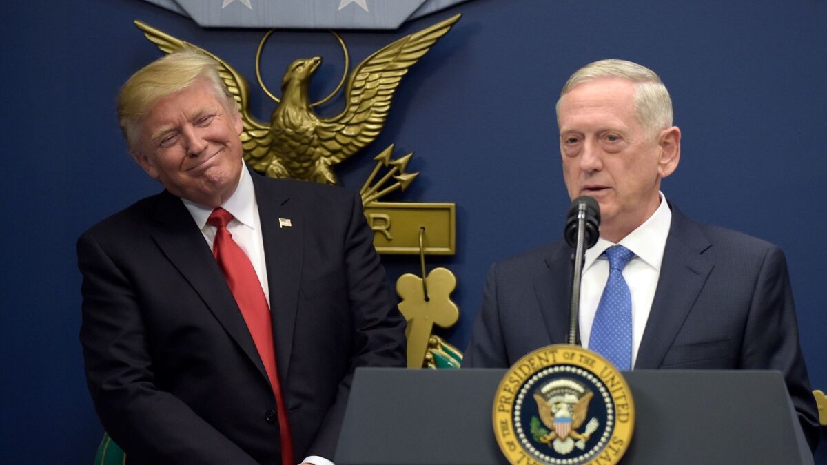 President Donald Trump, left, listens as Defense Secretary James Mattis, right, speaks at the Pentagon in Washington on Jan. 27.