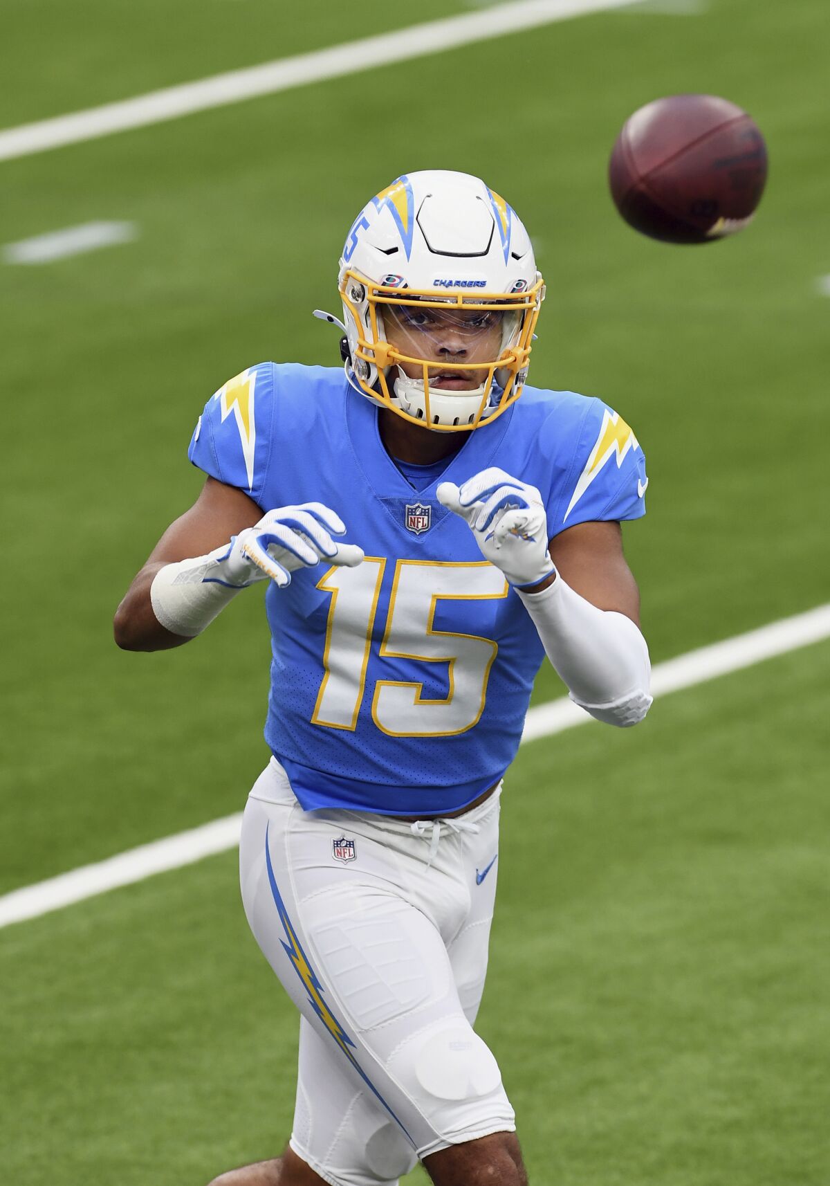 Chargers wide receiver Jalen Guyton catches passes before a game.