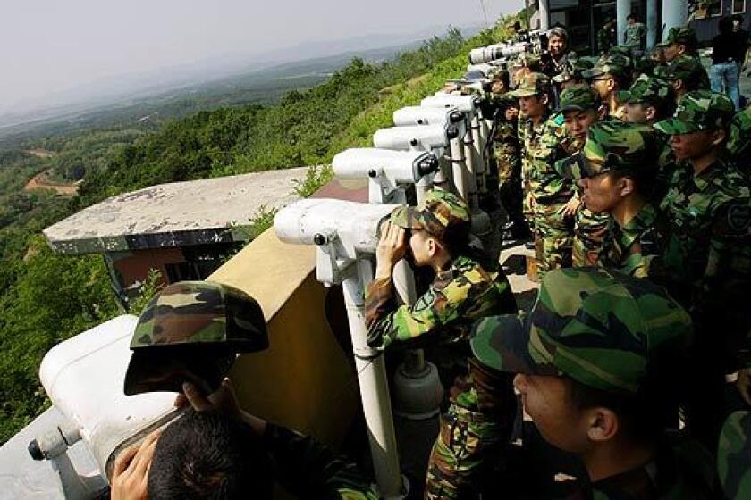 South Korean soldiers watch North Korea from Dora Observation Post in a demilitarized zone near the border. Tensions have been increasing since a North Korean nuclear test on Monday, followed by the launch of five short-range missiles. Today, North Korea said it would attack South Korea if any of the north's ships were intercepted as part of a U.S.-led initiative to stem the world trade in nuclear weapons.