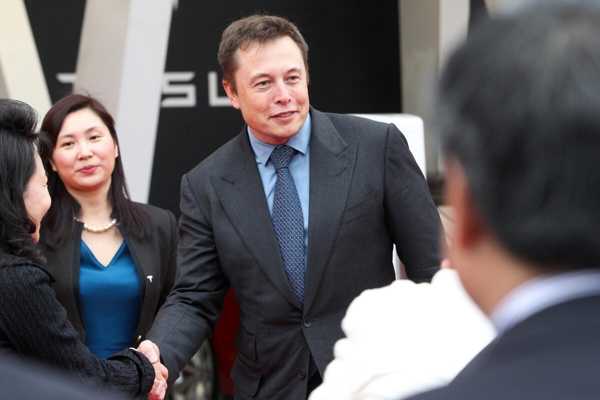 Elon Musk, chief executive of electric car maker Tesla Motors, attends a ceremony in Shanghai as the company delivers Model S cars to its first buyers in China.